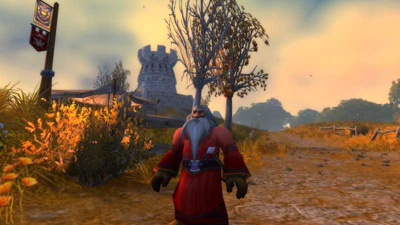 A Dwarf Priest in Westfall looking awesome with a tower in the background.